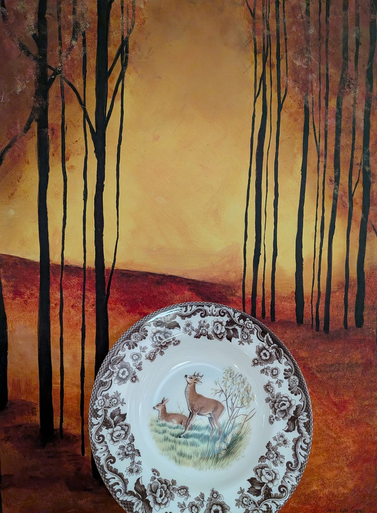 A painted forest at dusk with a woodland deer plate resting in front